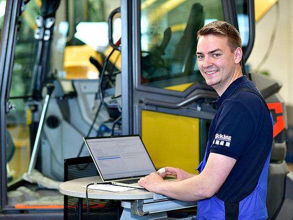 Ein Mitarbeiter der Martin Sicking GmbH in Stadtlohn führt eine Diagnose an einer Baumaschine durch